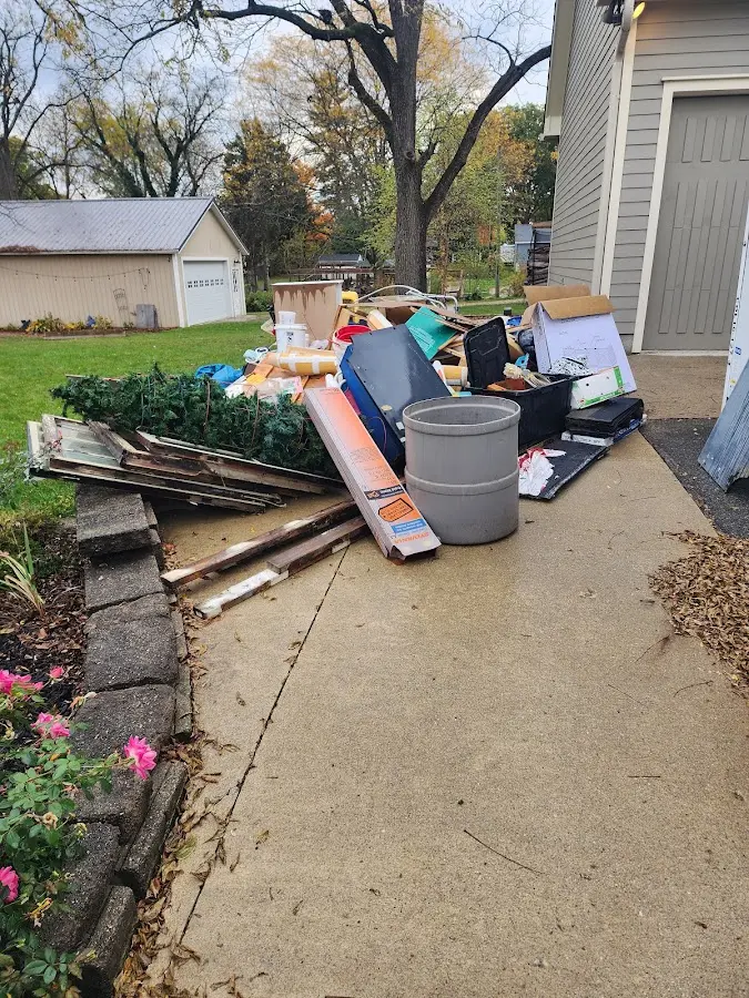 Dumpster being loaded with debris for Estate Cleanout Dumpster Rental in Milton